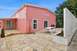 a pink building with a picnic table in front of it at The Pink Lodge in Lorne
