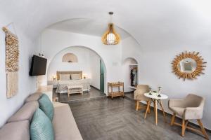 a living room with a couch and a bed at Villa Thiranthemis in Fira
