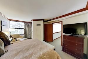 a hotel room with a bed and a flat screen tv at Resort at Squaw Creek's 810 & 812 in Olympic Valley