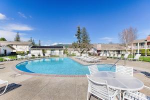 una piscina con sillas blancas y una mesa en Silverado Resort and Spa 266 & 267, en Napa