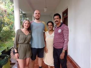 a group of people standing in front of a house at Sudu Neluma Home Stay in Polonnaruwa