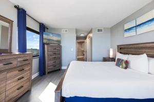 a bedroom with a large bed and a window at Oceanfront Penthouse, Two-Story, 3 Bedrooms in Myrtle Beach +30 photos