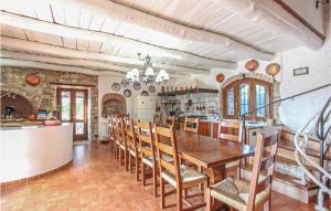 a kitchen and dining room with a wooden table and chairs at Cozy Home In Fragneto Monforte With House A Panoramic View in Fragneto Monforte