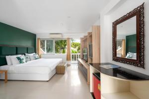 a bedroom with a white bed and a mirror at 4U Resort Samui in Lamai +37 photos