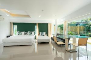 a bedroom with a bed and a glass table at 4U Resort Samui in Lamai