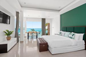 a bedroom with a large bed and a dining room at 4U Resort Samui in Lamai