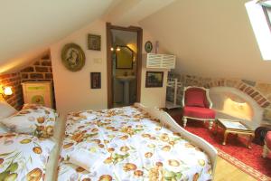 a bedroom with a bed, chair, table and window at Palazzo Drusko Deluxe Rooms in Kotor