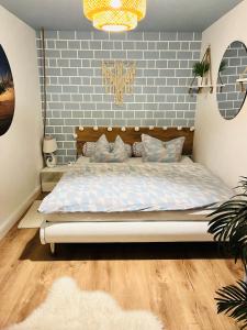 a bedroom with a bed with a brick wall at Extravagantes Apartment in Potsdam