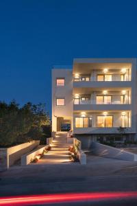 a large white building with lights in front of it at SII City Luxury Suites in Rethymno Town