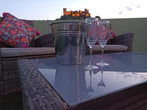 a glass table with three wine glasses on it at La Casona Verde in Almodóvar del Río