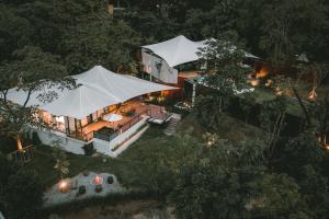 an aerial view of a house with a white tent at Te Mata Glamping in Nong Nam Daeng