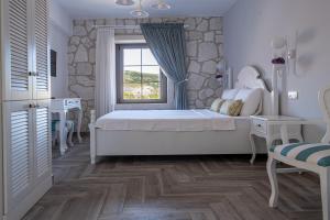 um quarto com uma cama grande e uma janela em TaşAda Hotel - Special Class em Bozcaada