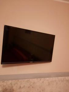 TV de pantalla plana colgada en la pared en Albergo la Valle en Daone
