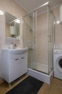 een badkamer met douche en wastafel en een wasmachine bij Ivan Apartment in Dubrovnik +16 foto's