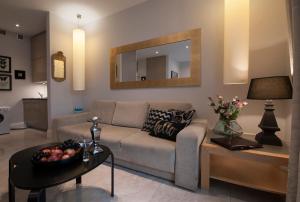 a living room with a couch and a table at IRS ROYAL APARTMENTS Apartamenty IRS Willa Krystyna in Sopot