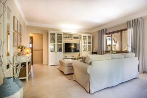 A television and/or entertainment centre at Casa Azul Stylish beach house for 4 adults and 1 child in Cala Llombards