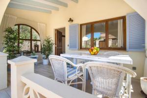 a kitchen with a table and chairs on a patio at Casa Azul Stylish beach house for 4 adults and 1 child in Cala Llombards in Cala Llombards