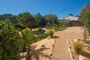 A garden outside Casa Azul Stylish beach house for 4 adults and 1 child in Cala Llombards