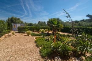 A garden outside Casa Azul Stylish beach house for 4 adults and 1 child in Cala Llombards