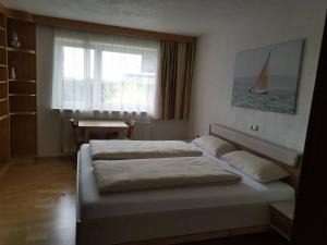 a bedroom with two beds in front of a window at Wei Wei's Hostel in Ehenbichl