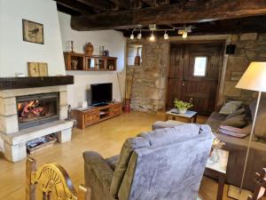 a living room with a couch and a fireplace at Alberroakoborda in Ituren