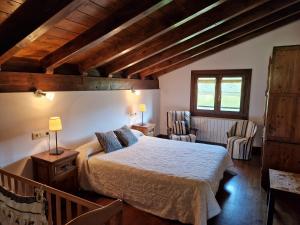 a bedroom with a bed in a room with wooden ceilings at Alberroakoborda in Ituren