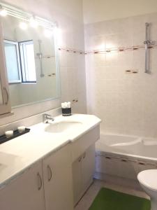 ein weißes Badezimmer mit einem Waschbecken und einer Badewanne in der Unterkunft My Way Hotel in Athen