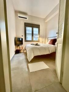 a bedroom with a bed and a television in it at Nikaia Metro House in Piraeus