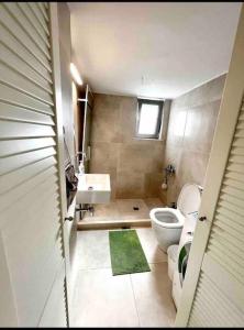 a bathroom with a toilet and a sink at Nikaia Metro House in Piraeus