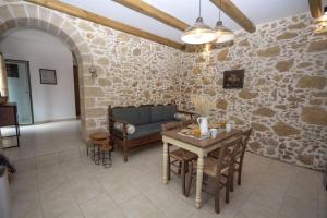 a living room with a couch and a table at Pamelas House with Jacuzzi in Kissamos