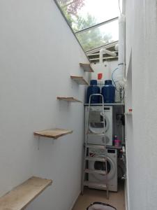 a laundry room with a washing machine and a window at Arman Group Basement Loft in Athens