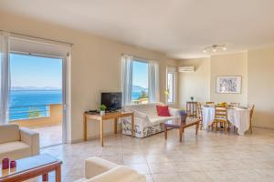 a living room with a view of the ocean at Epidavros Land villa Antigoni in Ancient Epidavros