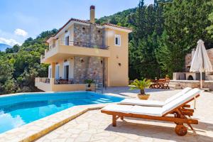 a villa with a swimming pool and a house at Epidavros Land villa Antigoni in Ancient Epidauros