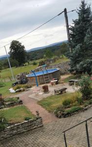 a building with a blue roof in a garden at Gites les Gambes in Échenoz-le-Sec