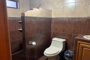 a bathroom with a toilet and a sink at OYO Hotel Castillo Santa Cecilia in Tapalpa