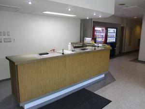 a reception desk in an office with a counter at Hotel Tetora HonHachinohe in Hachinohe