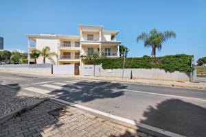 an empty street in front of a large building at Varandas do Sol - Olhos de Água in Albufeira