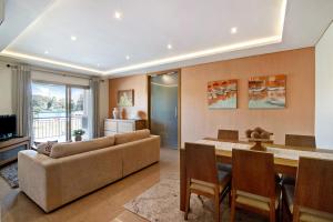 a living room with a couch and a table at Varandas do Sol - Olhos de Água in Albufeira