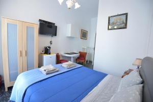 a bedroom with a blue bed in a room at B&B CASAVACANZE CHIESA MADRE in Carovigno