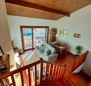 a living room with a couch and a table and a window at CAN ROC in Camprodon