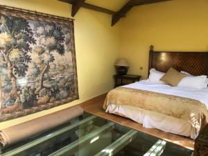 a bedroom with a bed and a tapestry on the wall at The Meeting House - Atmospheric 16th Century Merchants House in Ashburton