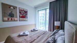 Posteľ alebo postele v izbe v ubytovaní NA WYDMIE APARTAMENT - Rezydencja Niechorze 111