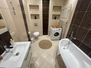 W łazience znajduje się umywalka i pralka. w obiekcie AL-DOM Apartament Ogrodowa Bocianie Gniazdo z garażem w Kołobrzegu +10 zdjęć