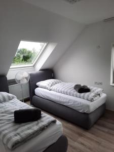 a room with two beds and a window at Ferienwohnung Apartment - Free Parking - WiFi - Kitchen in Essen