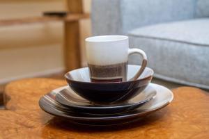 a coffee cup and saucers on a table at Repose Stay - Karen, 2 Bedroom, WiFi,Parking, CCTV in Nairobi +16 photos