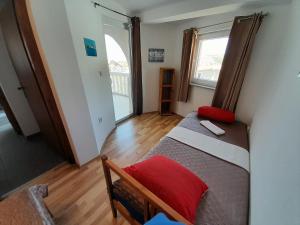 a small bedroom with a bed and a window at Tea-Dream house in Cesarica