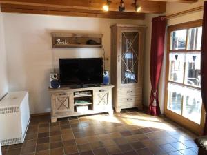 a living room with a flat screen tv on a stand at Ferienhaus Walter im Waldferiendorf in Regen
