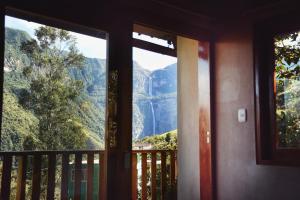 a room with a window looking out at a mountain view at Gocta Miradors Deluxe in Cocachimba