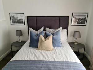 a bedroom with a bed with blue and white pillows at Apartments GB in Mostar