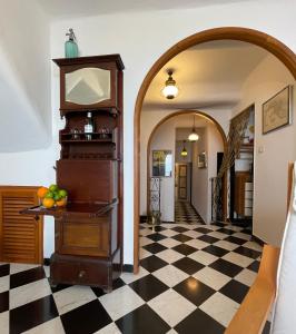 a hallway with a black and white checkered floor at La Lampara Camogli in Camogli +29 photos